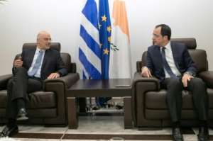 Cypriot Foreign Minister Nikos Christodoulides R met with his Greek counterpart Dendias at Larnaca airport near the end of the Greek diplomat's whistle-stop tour. By Stavros IOANNIDES PIOAFP