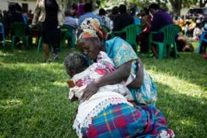Distraught family members gather after the fire at a school for the blind in Uganda. By BADRU KATUMBA AFP