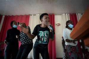 During a recent Sunday service, the church was heaving with music as an energetic choir urged congregants to rise to their feet. By Simon WOHLFAHRT AFP