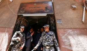 Egyptian police outside the charred Abu Sifin church located in the densely populated Imbaba neighbourhood west of the Nile river on August 14, 2022. By Khaled DESOUKI AFP