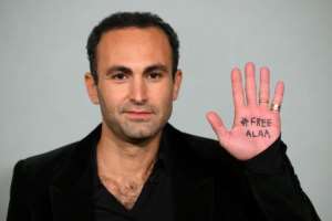 Egyptian-British actor Khalid Abdalla, poses in London with the words Free Alaa on his hand. By Daniel LEAL AFP