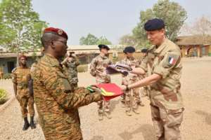 End of an era: Burkinabe and French officers at a flag-lowering ceremony in Ouagadougou on Saturday to mark the departure of French troops. By - The General Staff of the Armed Forces of Burkina FasoAFP