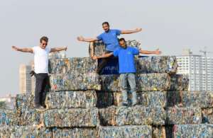 Environmental volunteers stand atop a pyramid of compressed plastic waste collected from the Nile, in Giza near the capital on World Cleanup Day, September 17, 2022. By Ahmed HASAN AFPFile