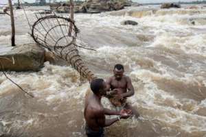 Fishing with a traditional net at the Wagenya falls. By Guerchom Ndebo AFP