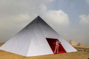 French photographer and street artist JR poses before his artwork Inside Out Giza. By Khaled DESOUKI AFP