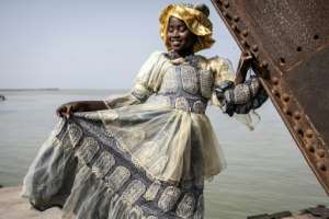 From the 18th century, the businesswomen would promenade through Saint-Louis wearing their vivid dresses to flaunt their wealth. By JOHN WESSELS AFP