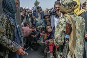 Global figures for those who were internally displaced or refugees were already high at the end of 2021, driven in part by the Taliban takeover of Afghanistan, which prompted many Afghans to try to leave the country. By BULENT KILIC AFP