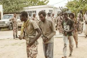 Handcuffed rebels from the FACT (Front for Change and Concord in Chad) armed group are displayed along with captured weapons and vehicles at army headquarters last May.  By Djimet WICHE (AFP)