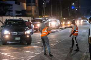 In the wealthy Ikoyi neighbourhood, the flow of people chasing money never stops. By Benson Ibeabuchi AFP