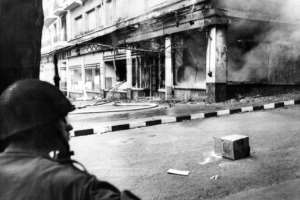 In this file picture taken on May 15, 1962, a French soldier looks at a store destroyed by a Molotov cocktail in Algiers. By - AFPFile