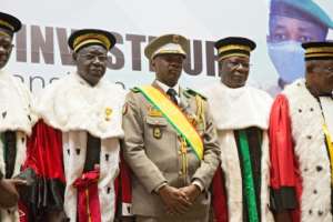 Interim president Colonel Colonel Assimi Goita, centre, stands next to members of Mali's Supreme Court at his swearing-in ceremony last June. By ANNIE RISEMBERG AFP