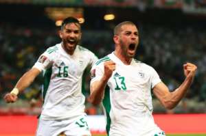 Islam Slimani R celebrates scoring the goal that gave Algeria victory over Cameroon in a 2022 World Cup play-off first leg in Douala on March 25, 2022.. By DANIEL BELOUMOU OLOMO AFP