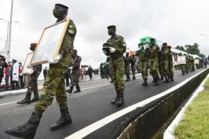 Ivorian soldiers in Abidjan carry the coffins of soldiers killed in the June 2020 attack in Kafolo. By SIA KAMBOU AFP