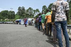 Ivorians queued up to get into Ghana after the three-year border closure. By Sia KAMBOU AFP
