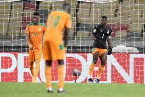 Ivory Coast captain Serge Aurier R finished the game in goal after Badra Ali Sangare hurt himself while conceding a bizarre equaliser. By CHARLY TRIBALLEAU AFP