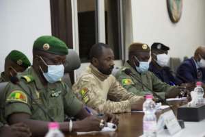 Junta leader Assimi Goita, centre, a former special forces colonel, pictured after the August 2020 coup. By Elonore HUGHES AFP