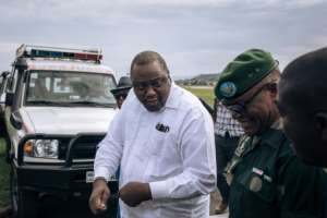Kenyatta in white visiting Goma this week. By ALEXIS HUGUET AFP