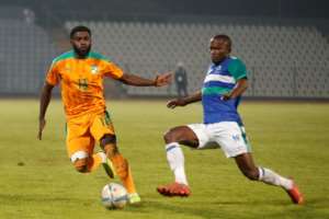 Lesotho defender Rethabile Rasethuntsa R fights for the ball with Ivory Coast substitute midfielder Jeremie Boga during a 2023 Africa Cup of Nations Group H qualifier in Soweto, South Africa on June 9, 2022.. By PHILL MAGAKOE AFP