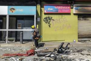 Loooting: Shopping malls were attacked after Zuma was jailed for contempt of court. By GUILLEM SARTORIO AFP
