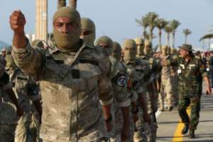 Masked Libyan soldiers take part in a military parade in the capital Tripoli on August 9, 2022. By Mahmud Turkia AFPFile