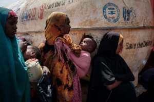 Mothers wait for high nutrition foods and health services at a camp for internally displaced persons in Baidoa, Somalia, on February 14, 2022. By YASUYOSHI CHIBA AFPFile