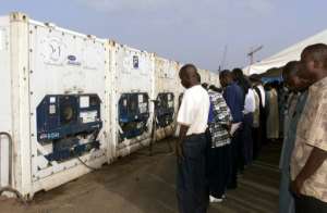 Mourners gather by containers at Dakar port holding victims after the disaster. By SEYLLOU AFPFile