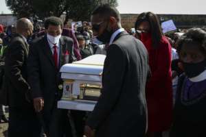 Nathaniel Julies' family carry his casket as hundreds of residents took to the street denouncing his death. By Ali Greef AFP