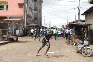 People flee while demonstrators are dispersed in the Cocody district of Abidjan on October 19, 2020, during a demonstration against the third mandate of outgoing Ivorian President Alassane Ouattara. By PATRICK FORT AFPFile