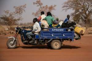 People flee with their belongings after a jihadist attack in rural northern Burkina Faso in April. Nearly a million people have been displaced. By OLYMPIA DE MAISMONT AFP
