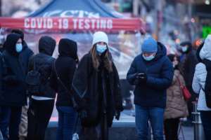 People queue at a street-side Covid-19 testing booth in New York's Times Square on December 20, 2021 as omicron was announced to be the dominant strain in the United States. By Ed JONES AFP