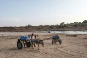 People take carts pulled by emaciated donkeys to the Shabelle River in Gode, Ethiopia, to draw water for their parched herds. By EDUARDO SOTERAS AFP