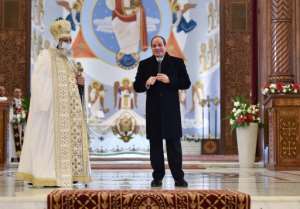 President Abdel Fattah al-Sisi alongside Pope Tawadros II during a Coptic Orthodox Christmas Eve mass at the Nativity of Christ Cathedral in Egypt's administrative capital east of Cairo on January 6, 2022. By - EGYPTIAN PRESIDENCYAFPFile