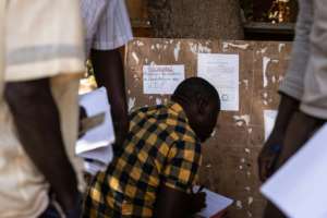 Recruit: A man writes a letter of application to enrol in the VDP at the regional governor's office in Ouagadougou. By OLYMPIA DE MAISMONT AFP