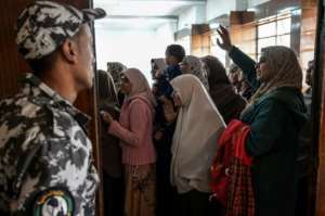 Relatives of Muslim Brotherhood members facing the death penalty try to wave to their loved ones at a hearing in December 2018. By Mohamed el-Shahed AFPFile