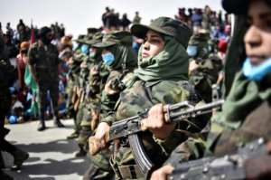 Sahrawi women soldiers parade on the 45th anniversary of the proclamation of the Sahrawi Arab Democratic Republic by the Polisario Front, at a refugee camp near the southwestern Algerian city of Tindouf, on February 27, 2021. By RYAD KRAMDI AFPFile