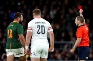 Sent-off Australian referee Angus Gardner R shows South Africa's Thomas du Toit L a red card. By Ian Kington AFP