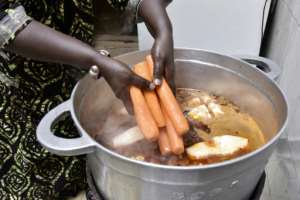 She says she learnt how to make the rice and fish dish from her mother. By SEYLLOU AFP