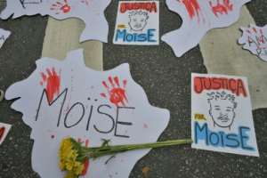 Signs lying on the pavement during a protest following the killing of 24-year-old Congolese refugee Moise Kabagambe in Brazil. By NELSON ALMEIDA AFPFile