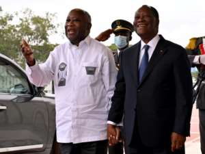 Smiles: Gbagbo, left, and Ouattara last July at the long-awaited meeting between the two former rivals. By Issouf SANOGO AFP