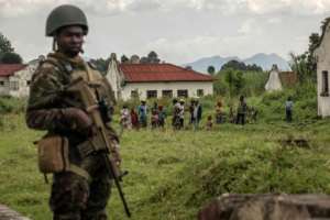 Soldiers deployed by the East African Council guarded the handover as villagers watched. By Guerchom Ndebo AFP