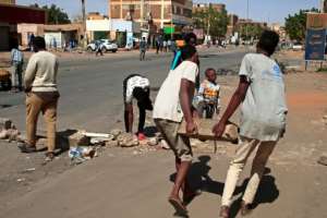Sudanese demonstrators built barricades in Khartoum using rocks. By - AFP