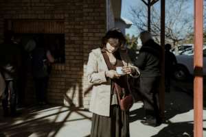 Sunday service: A worshipper enjoys tea at Orania's Dutch Reformed Church. By MARCO LONGARI AFP