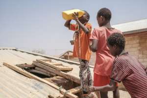 Thirst: Children queue to drink water at a cistern in the village of Adlale near Gode, Ethiopia. By EDUARDO SOTERAS AFP