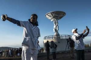 Time for a selfie: People take pictures in front of a radio dish during the satellite launch. By EDUARDO SOTERAS AFP