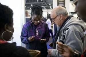 Vesela tried to woo reluctant customers with biscuits and protein bars at a recent food fair in Johannesburg's upmarket Sandton district. By EMMANUEL CROSET AFP