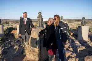 VIP guests Gaboilelwe Moroka and Bhelekazi Mabandla, centre and right, view Orania's Afrikaner statues. On the left is Louis Bothma, a historian and part of the welcoming committee. By MARCO LONGARI AFP