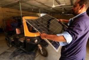 Workers assemble electric tuk-tuks in Khartoum: the three-wheelers take about eight hours to be fully charged. By ASHRAF SHAZLY AFP
