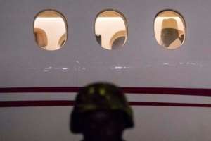 Yahya Jammeh looks through a plane window at Banjul airport as he flees for Equatorial Guinea in 2017. By STRINGER AFP