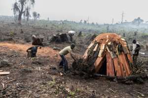 Youths tend a charcoal kin at the refugee camp in Kibati. By Guerchom Ndebo AFP