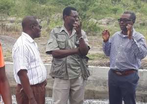Collins Donkor interacting with workers at the quarry site